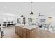 Open kitchen boasts an island, stainless steel appliances, and a dining area at 2417 Mayview Rd, Raleigh, NC 27607
