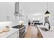 Modern kitchen with gas range, island, and dining area view at 2417 Mayview Rd, Raleigh, NC 27607