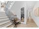 Elegant staircase with wood treads, black railings, and bright, natural light at 2417 Mayview Rd, Raleigh, NC 27607