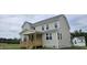 Rear exterior featuring siding, many windows and a charming back porch perfect for outdoor relaxation at 271 White Azalea Way, Homesite 30, Benson, NC 27504
