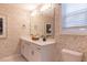 Bathroom with double vanity, decorative wallpaper, and a large mirror, creating a serene atmosphere at 271 White Azalea Way, Homesite 30, Benson, NC 27504