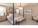 This bedroom features a four-poster bed, chandelier, and neutral décor for a relaxing space at 271 White Azalea Way, Homesite 30, Benson, NC 27504