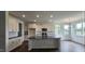 Modern kitchen featuring white cabinets, granite countertops, a large island, and stainless steel appliances at 271 White Azalea Way, Homesite 30, Benson, NC 27504
