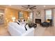 Living room features a fireplace, wood accent wall, sofa, and windows with patterned curtains at 271 White Azalea Way, Homesite 30, Benson, NC 27504