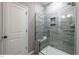 Modern bathroom features a glass shower with tiled walls and built-in shelving at 294 White Azalea Way, Homesite 74, Benson, NC 27504