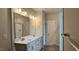 Bathroom featuring double vanity sinks, modern lighting, and a framed mirror at 294 White Azalea Way, Homesite 74, Benson, NC 27504