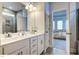 Bathroom with double vanity and granite tile. Doorway leads to bedroom at 294 White Azalea Way, Homesite 74, Benson, NC 27504