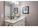Bathroom with double vanity, white cabinets, and modern fixtures and decor at 294 White Azalea Way, Homesite 74, Benson, NC 27504