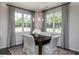 Bright dining room with large windows and a stylish chandelier above a wooden table at 294 White Azalea Way, Homesite 74, Benson, NC 27504