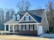 Charming home featuring a gray exterior, brick accents, and a welcoming front porch at 294 White Azalea Way, Homesite 74, Benson, NC 27504