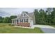 Beautiful home exterior featuring a well-manicured lawn and a two-car garage at 294 White Azalea Way, Homesite 74, Benson, NC 27504