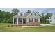 Charming single-Gathering home with tan siding, brick foundation, and a cozy front porch at 294 White Azalea Way, Homesite 74, Benson, NC 27504