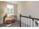 Hallway nook with decorative table, lamp, and woven stools beneath a bright window at 294 White Azalea Way, Homesite 74, Benson, NC 27504