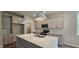 Well-lit kitchen with a large island, modern fixtures, and stainless steel appliances at 294 White Azalea Way, Homesite 74, Benson, NC 27504