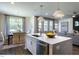 Modern kitchen island with quartz countertop and stainless steel dishwasher at 294 White Azalea Way, Homesite 74, Benson, NC 27504