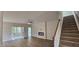 Open living area with modern fireplace, stairs, and adjacent dining room at 294 White Azalea Way, Homesite 74, Benson, NC 27504