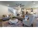 Open-concept living room and kitchen with a neutral color palette and plush sofas at 294 White Azalea Way, Homesite 74, Benson, NC 27504