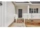 Dark gray front door with white columns and brick base at 35 S Rowsham Pl, Smithfield, NC 27577