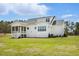 Home featuring a screened-in porch, white trim, and spacious backyard at 3804 Cobbler View Way, Fuquay Varina, NC 27526