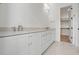 Bathroom featuring double sinks, white cabinets, and marble floors at 3804 Cobbler View Way, Fuquay Varina, NC 27526