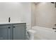 Bathroom featuring a gray vanity, black fixtures, a toilet, and a bathtub at 3804 Cobbler View Way, Fuquay Varina, NC 27526