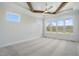 Bright bedroom with a wood-beamed ceiling, shiplap accent wall, and multiple windows at 3804 Cobbler View Way, Fuquay Varina, NC 27526