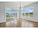 Sunlit dining room with hardwood floors, modern chandelier and sliding glass doors to a porch at 3804 Cobbler View Way, Fuquay Varina, NC 27526