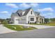 Attractive white home with a three-car garage, driveway, manicured landscaping, and covered porch at 3804 Cobbler View Way, Fuquay Varina, NC 27526