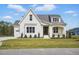 Lovely white brick home with a dark wood front door, two-car garage, well-manicured lawn, and tidy landscaping at 3804 Cobbler View Way, Fuquay Varina, NC 27526