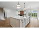Stylish kitchen island with stainless steel appliances, opening to living area and staircase at 3804 Cobbler View Way, Fuquay Varina, NC 27526