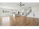 Spacious living room flows into the kitchen, with white cabinets, an island, and stainless steel appliances at 3804 Cobbler View Way, Fuquay Varina, NC 27526