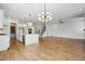 Spacious open-concept living area with island, hardwood floors, and modern lighting at 3804 Cobbler View Way, Fuquay Varina, NC 27526