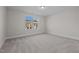 Spacious bedroom with neutral carpeting and window view at 811 Pryor St, Mebane, NC 27302