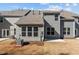 Rear view of the house showcasing a sunroom and patio at 811 Pryor St, Mebane, NC 27302