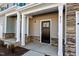 Townhome's front entrance with stone accents and a dark brown door at 813 Pryor St, Mebane, NC 27302