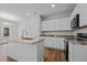 Modern kitchen with white cabinets, granite countertops, and stainless steel appliances at 813 Pryor St, Mebane, NC 27302