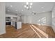 Open living room with hardwood floors and kitchen island view at 813 Pryor St, Mebane, NC 27302