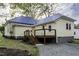 Exterior shot of a deck connected to a home with a blue metal roof and yellow siding at 915 S 3Rd St, Sanford, NC 27330