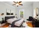 Staged bedroom featuring a modern bed, sleek furniture, and stylish decor at 915 S 3Rd St, Sanford, NC 27330