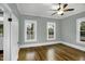 Bright bedroom with hardwood floors, ceiling fan, and natural light from double-hung windows at 915 S 3Rd St, Sanford, NC 27330