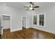 A bright bedroom with hardwood floors, a ceiling fan, and a walk-in closet at 915 S 3Rd St, Sanford, NC 27330
