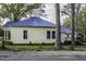 Side view showcasing the home's siding, windows, and blue metal roof at 915 S 3Rd St, Sanford, NC 27330