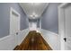 Hallway with hardwood floors, white paneled wainscoting, and neutral paint at 915 S 3Rd St, Sanford, NC 27330
