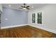Living room featuring beautiful hardwood floors, a ceiling fan, and a freshly painted accent wall at 915 S 3Rd St, Sanford, NC 27330