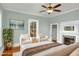 Staged bedroom with two sitting chairs and a view of the fireplace at 915 S 3Rd St, Sanford, NC 27330