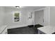 Mud room features a door to the outside, gray tile floor and a nearby entrance to the laundry room at 915 S 3Rd St, Sanford, NC 27330