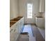 Unfinished kitchen area with ample cabinet space, awaiting personalization at 3341 Colby Chase Dr, Apex, NC 27539
