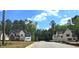 View of newly constructed homes on a street lined with trees under a sunny sky at 3341 Colby Chase Dr, Apex, NC 27539