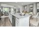Open concept kitchen with white cabinets, granite island, and breakfast bar at 2103 Pitchfork Ln, Durham, NC 27713