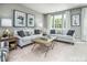 Bright living room with neutral walls, comfy sofas, and a coffee table at 2103 Pitchfork Ln, Durham, NC 27713